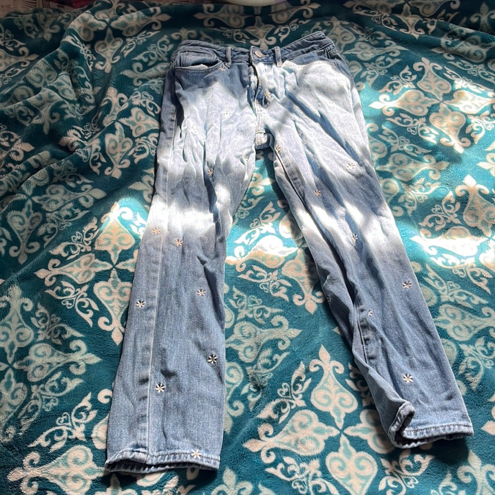 Jeans with white and yellow daisies from PacSun